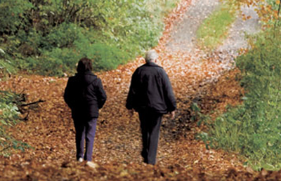 Couple Walking Through Woods